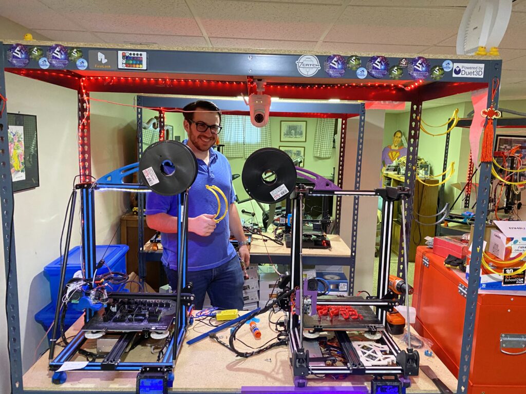 A DDA team member in the workshop with large-format 3D printers