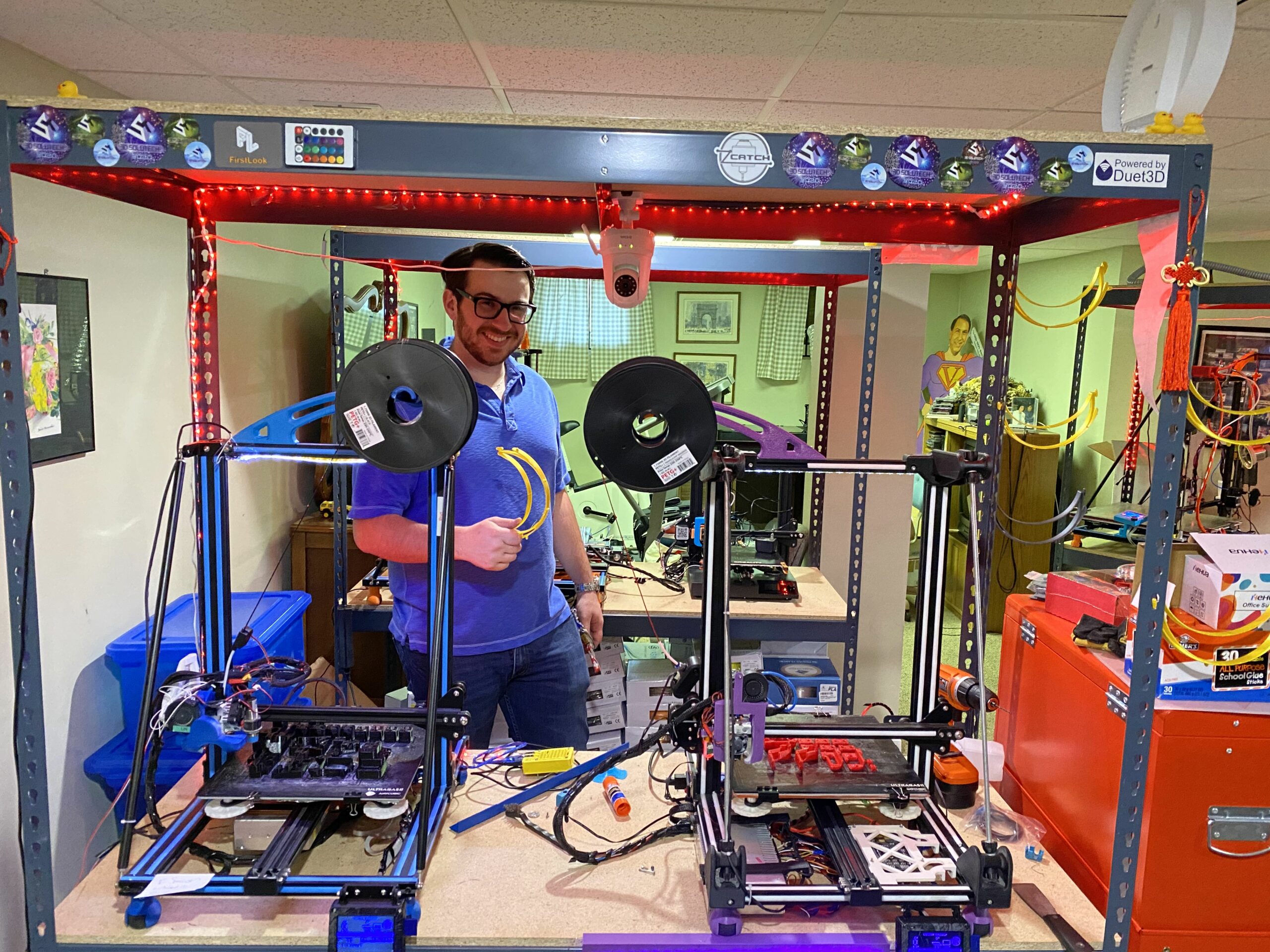 DDA team member among custom 3D printers in the workshop