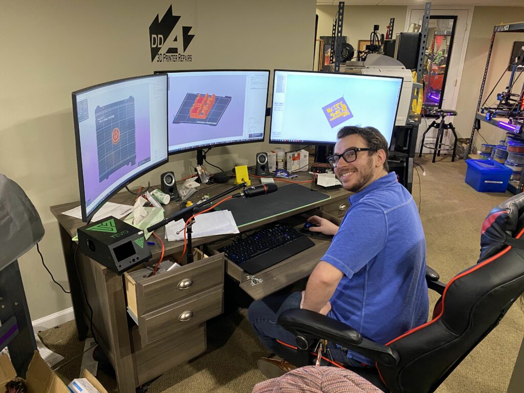 A DDA team member working on CAD designs at the workshop