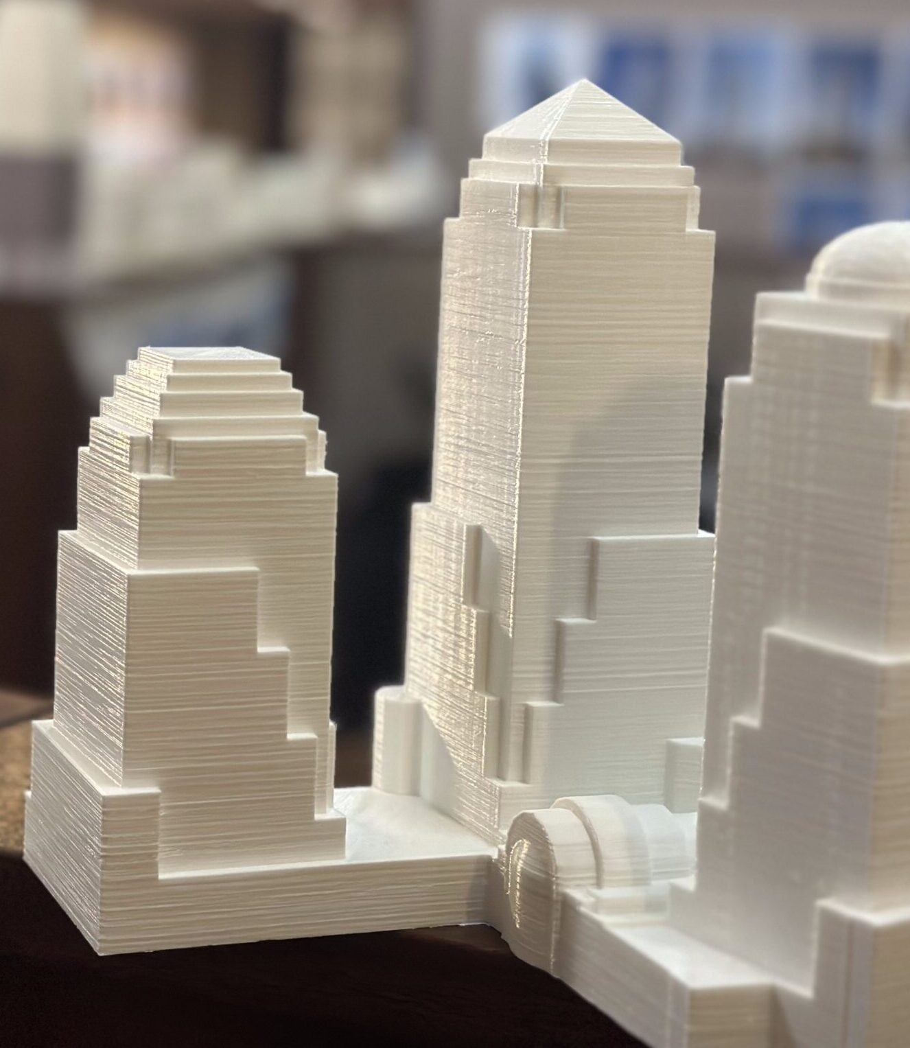 White architectural model showing towers and lower buildings at a small scale