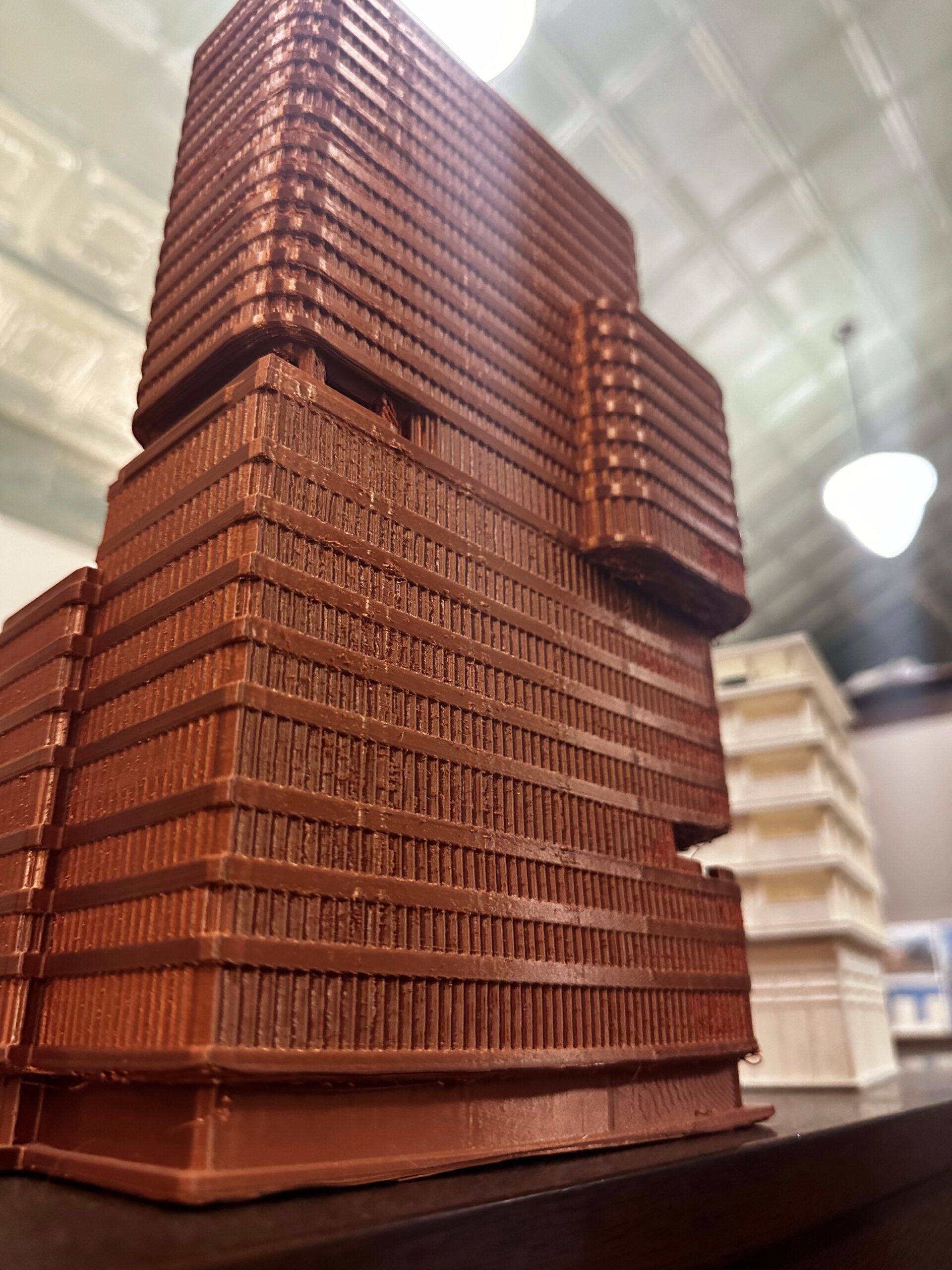 Close view of a reddish architectural tower model showing printed facade detail and layer texture